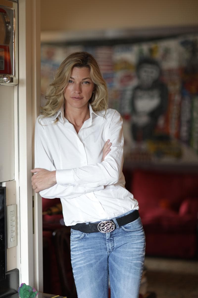 Nicole Junkermann at home beside colourful contemporary art for the Nicole Junkermann Art Review